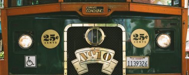 Photo of front of Santa Cruz Trolley car No. 10 publicizing fare of 25 cents . Includes sticker with handicapped accessible symbol.